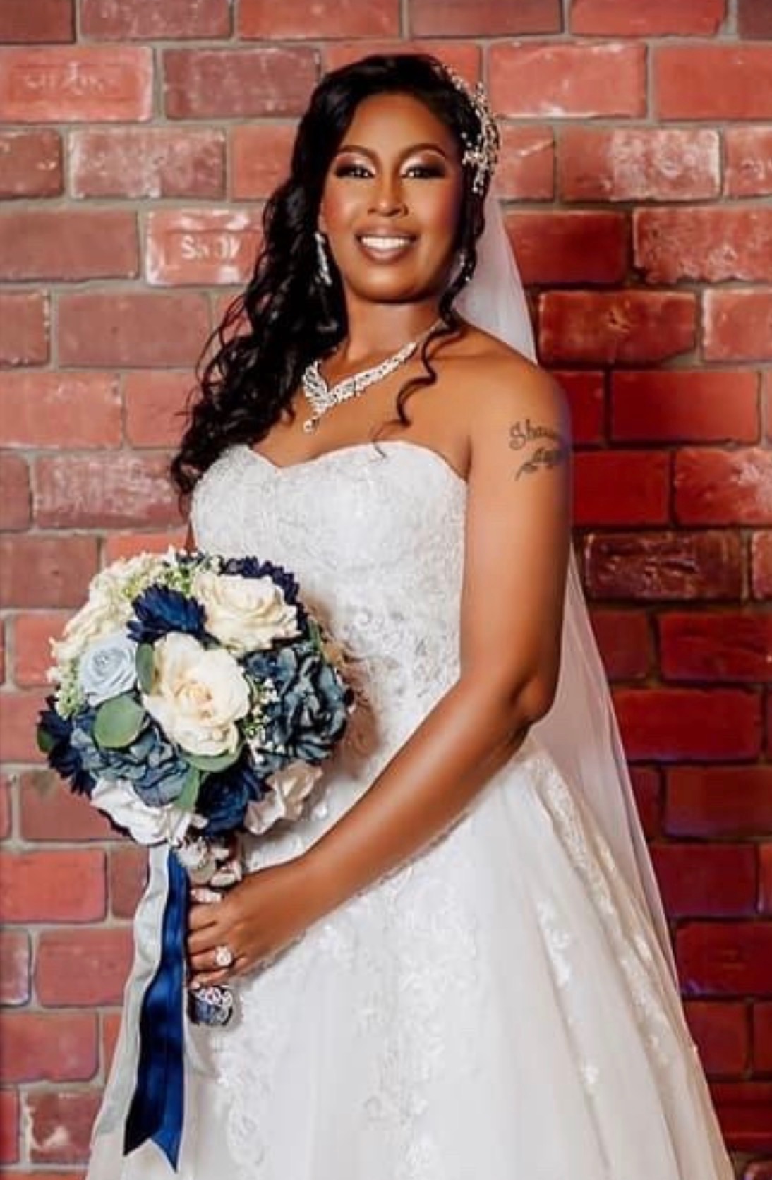 Bride with veil and bouquet — finished wedding hair styling
